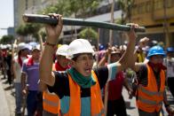 FILE - In this March 25, 2014, file photo, Miners chant anti government slogans during a protest organized by artisanal and small-scale gold miners in Lima, Peru. The miners marched in the country's capital for the sixth day asking the government to repeal regulations aimed at formalizing informal miners. The government’s vow to enforce a ban on illegal mining is raising fears of bloody confrontations. (AP Photo/Rodrigo Abd, File)