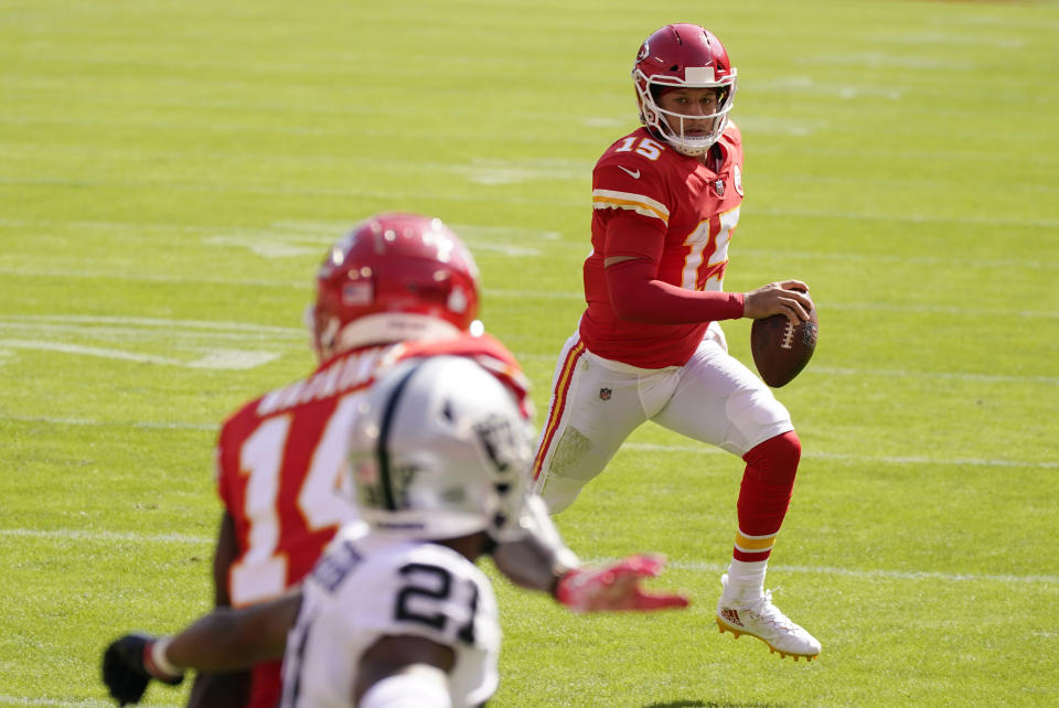 Kansas City Chiefs quarterback Patrick Mahomes (15) scores on a 3-yard touchdown run during the first half of an NFL football game against the Las Vegas Raiders, Sunday, Oct. 11, 2020, in Kansas City. (AP Photo/Charlie Riedel)