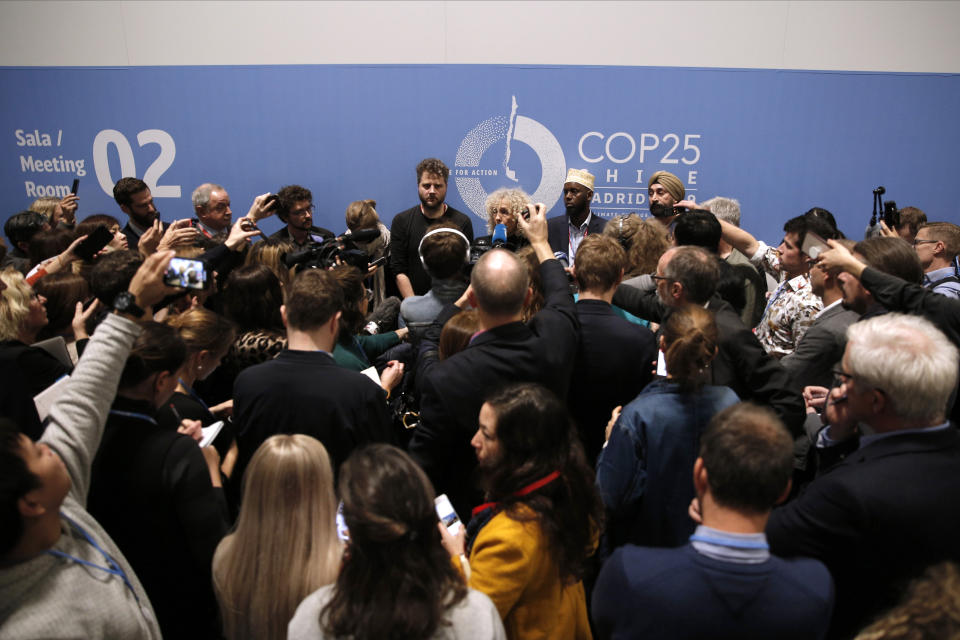 Visitors attend a briefing at the COP25 climate talks congress in Madrid, Spain, Saturday, Dec. 14, 2019. The United Nations Secretary-General has warned that failure to tackle global warming could result in economic disaster. (AP Photo/Manu Fernandez)