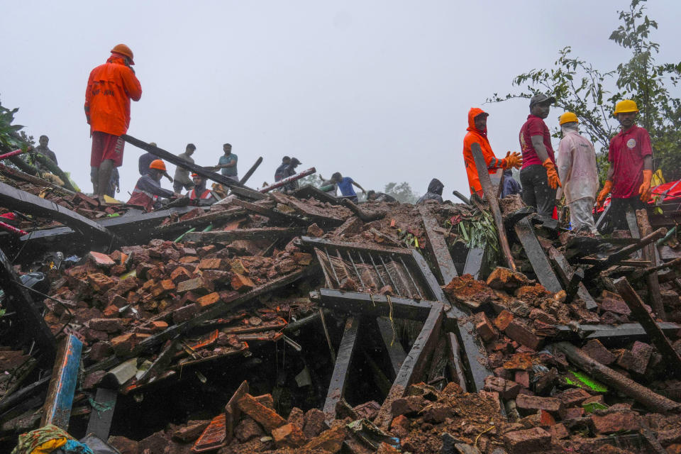 Rescuers work at a site of a landslide triggered by torrential rains in Raigad district, western Maharashtra state, India, Thursday, July 20, 2023. While some people are reported dead many others feared trapped under piles of debris. (AP Photo/Rafiq Maqbool)