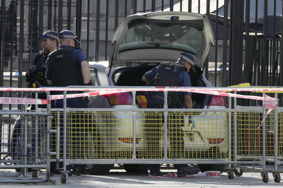 Police at the scene after a car collided with the gates of Downing Street in London in London, Thursday, May 25, 2023. Police say a car has collided with the gates of Downing Street in central London, where the British prime minister's home and offices are located. The Metropolitan Police force says there are no reports of injuries. Police said a man was arrested at the scene on suspicion of criminal damage and dangerous driving. It was not immediately clear whether the crash was deliberate. (AP Photo/Alastair Grant)