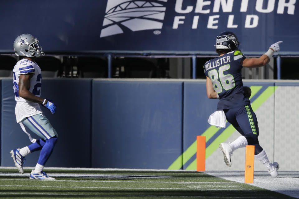 Seattle Seahawks tight end Jacob Hollister, right scores a touchdown past Dallas Cowboys cornerback Daryl Worley, left, during the second half of an NFL football game, Sunday, Sept. 27, 2020, in Seattle. (AP Photo/John Froschauer)