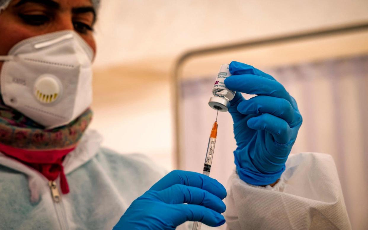 A health worker prepares dose of the AstraZeneca jab against the coronavirus, during a vaccination campaign at the El-Arjate prison near the capital Rabat, on May 26, 2021. (Photo by FADEL SENNA / AFP) (Photo by FADEL SENNA/AFP via Getty Images) - FADEL SENNA/AFP