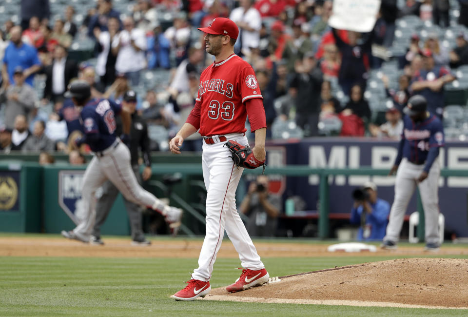 Los Angeles Angels starting pitcher Matt Harvey walks off the mound after giving up a three-run home run to Minnesota Twins' Jonathan Schoop, background left, during the second inning of a baseball game Thursday, May 23, 2019, in Anaheim, Calif. (AP Photo/Marcio Jose Sanchez)