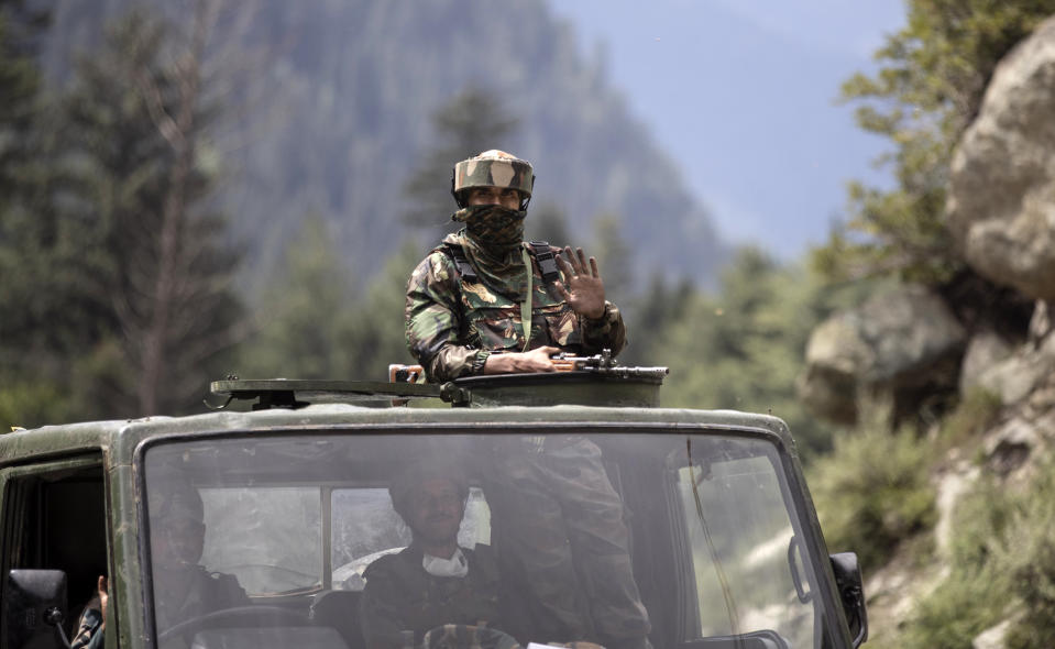 An Indian army soldier keeps guard on top of his vehicle as their convoy moves on the Srinagar- Ladakh highway at Gagangeer, northeast of Srinagar, Indian-controlled Kashmir, Tuesday, Sept. 1, 2020. India said Monday its soldiers thwarted “provocative” movements by China’s military near a disputed border in the Ladakh region months into the rival nations’ deadliest standoff in decades. China's military said it was taking “necessary actions in response," without giving details. (AP Photo/Mukhtar Khan)