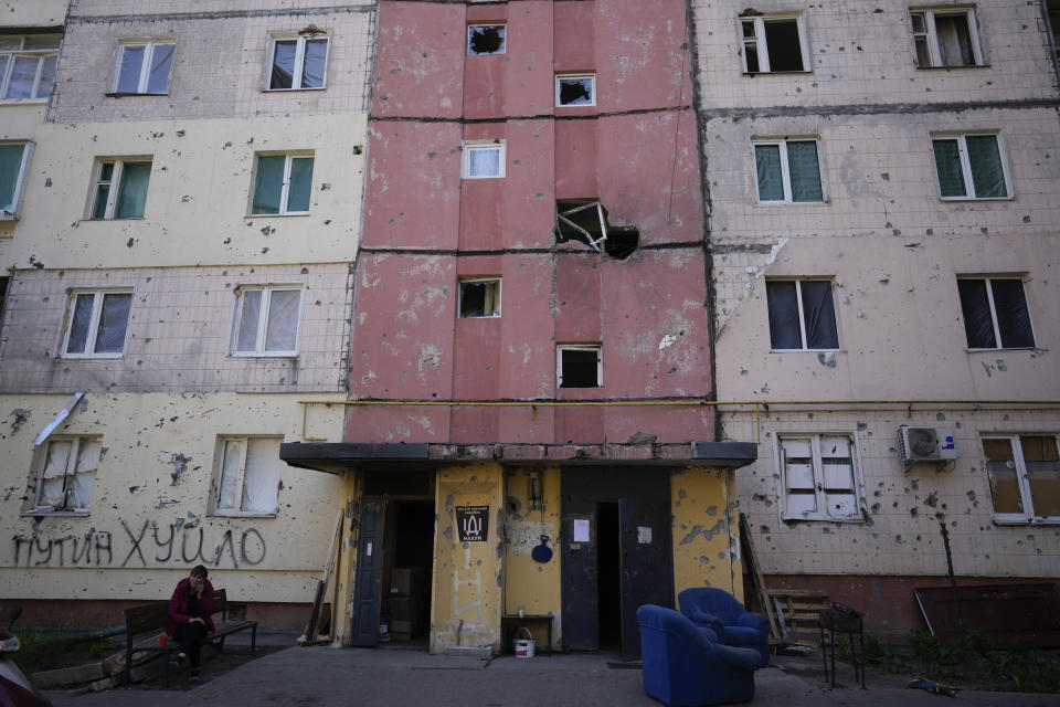 A resident sits outside a house ruined by shelling in Irpin, outskirts of Kyiv, Ukraine, Tuesday, May 24, 2022. (AP Photo/Natacha Pisarenko)