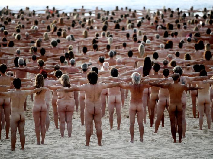 Group of nude people on Bondi Beach for cancer awareness photo shoot