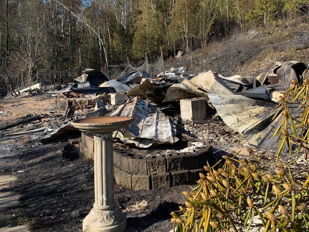 A bird bath is all that's left standing at Annie Stewart's parents' place, the only residence lost in the fire at Bocabec, near Saint Andrews.   (Submitted by Annie Stewart - image credit)
