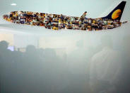 Jet Airways employees are reflected in a glass window at its headquarters in Mumbai, India, April 18, 2019. REUTERS/Francis Mascarenhas