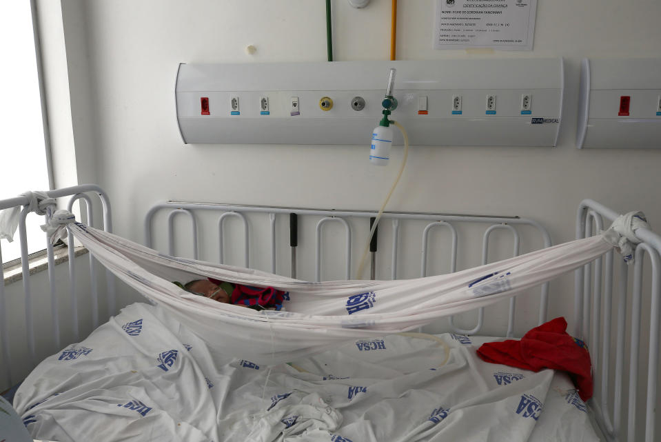 An Yanomami baby lies in a hammock while receiving medical assistance at the Santo Antonio Children's Hospital, in Boa Vista, Roraima state, Brazil, Thursday, Jan 26, 2023. Brazil's government declared a public health emergency for the Yanomami people in the Amazon, who are suffering from malnutrition and diseases such as malaria. (AP Photo/Edmar Barros)