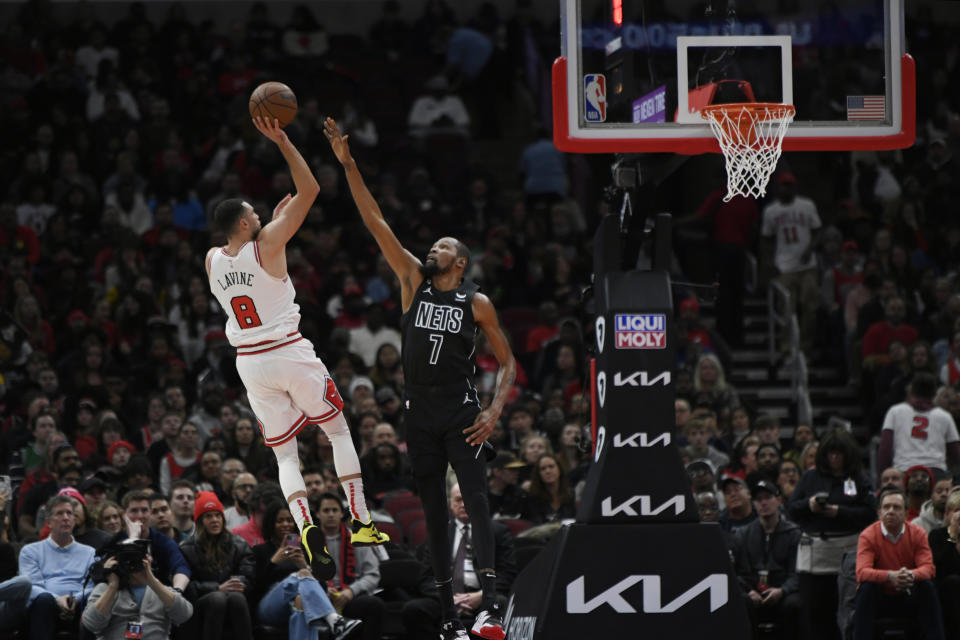 Chicago Bulls' Zach LaVine (8) shoots over Brooklyn Nets' Kevin Durant (7) during the first half of an NBA basketball game Wednesday, Jan. 4, 2023, in Chicago. (AP Photo/Paul Beaty)