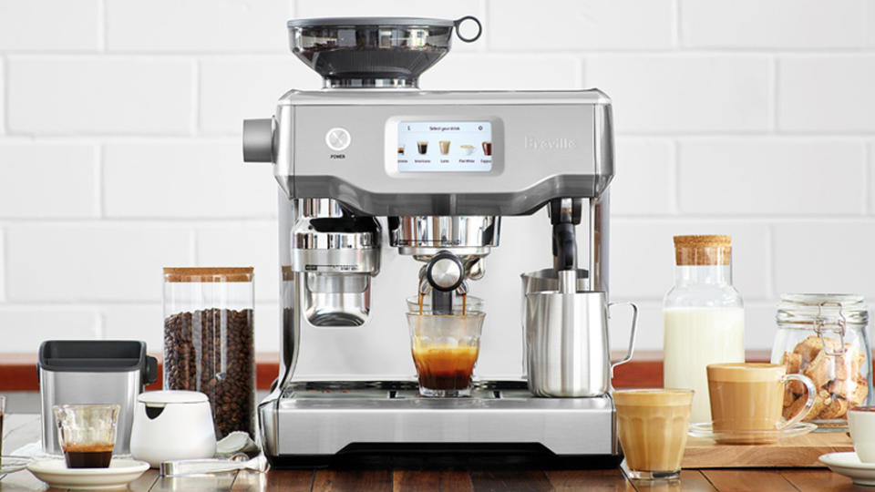 A Breville Oracle Touch espresso machine with a cup of espresso on the drop tray