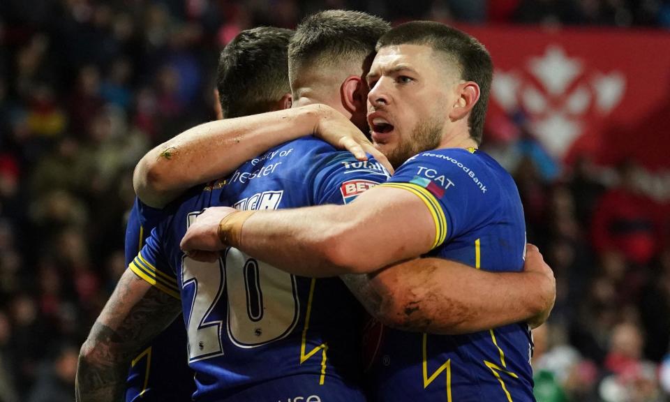 <span>Warrington’s Connor Wrench (20) celebrates with teammates after scoring their fourth try against Hull KR.</span><span>Photograph: Mike Egerton/PA</span>