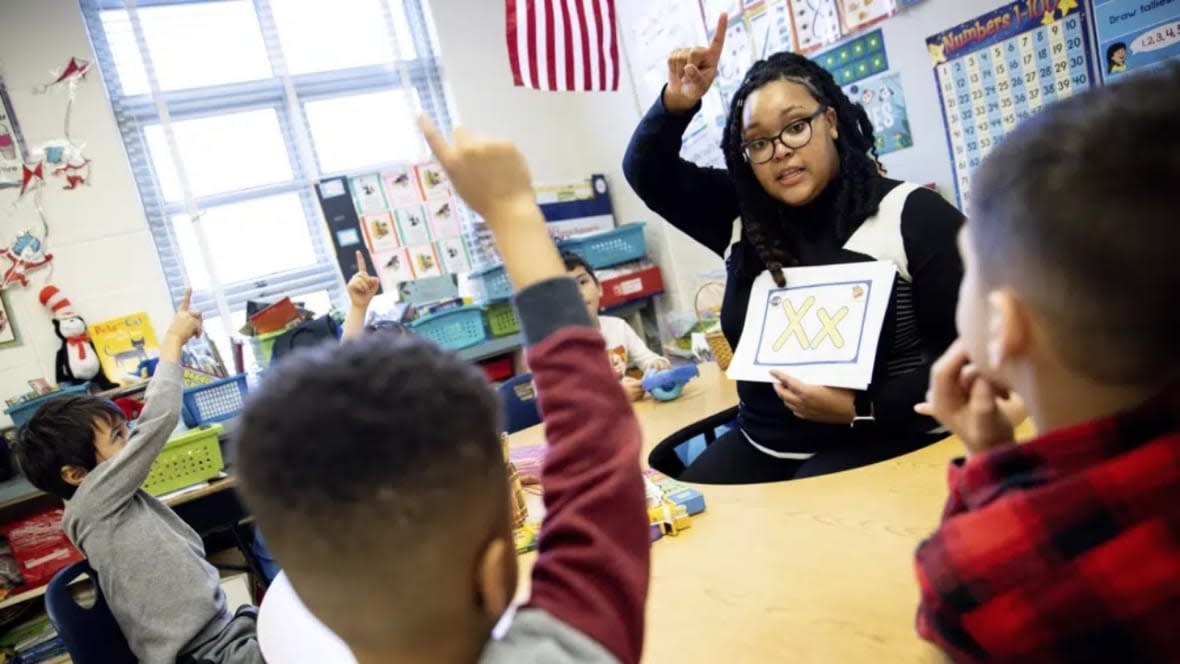 Student teacher Lana Scott, who plans to graduate from Bowie State University in the spring of 2023, teaches the alphabet to a small group of kindergartners at Whitehall Elementary School in Bowie, Maryland. (Photo: Julia Nikhinson/AP)