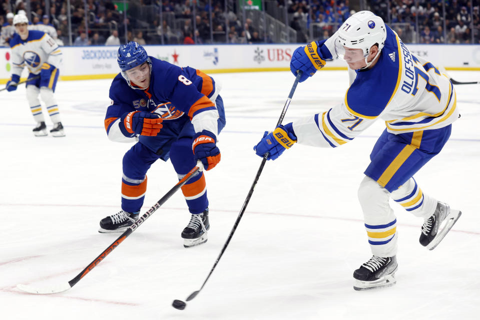 Buffalo Sabres' Victor Olofsson (71) shoots past New York Islanders' Noah Dobson (8) during the first period of an NHL hockey game Tuesday, March 7, 2023, in Elmont, N.Y. (AP Photo/Jason DeCrow)