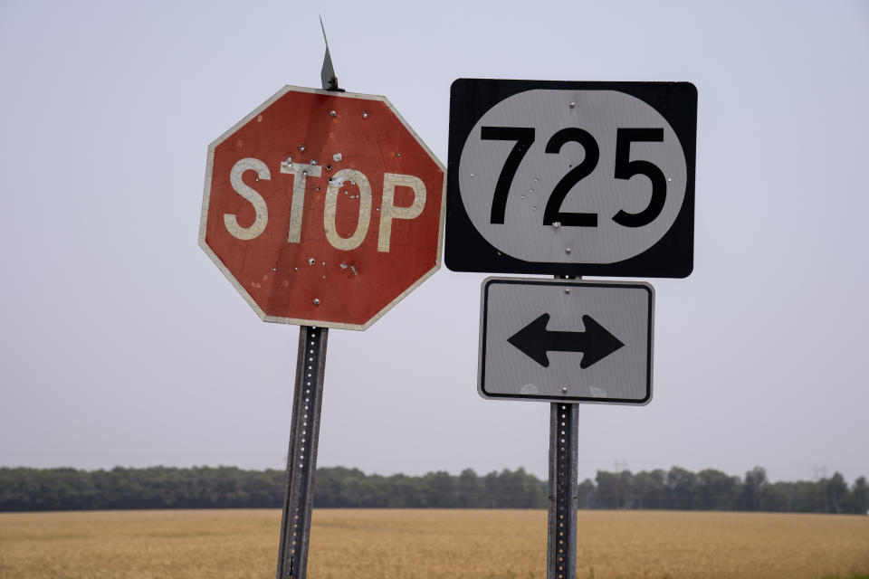 Road signs riddled with bullet holes stand along a rural road in West Paducah, Ky., Sunday, June 4, 2023. (AP Photo/David Goldman)