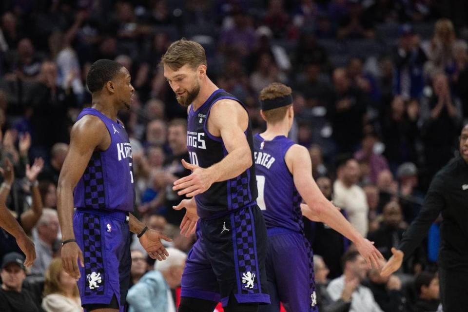 Sacramento Kings guard De’Aaron Fox (5) and center Domantas Sabonis (10) celebrate their lead during an NBA game against the Houston Rockets on Sunday at Golden 1 Center.