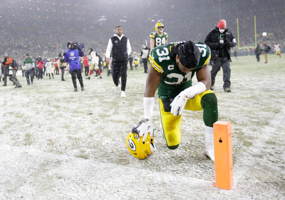 Green Bay Packers safety Adrian Amos takes a knee in the end zone after a 13-10 loss to the San Francisco 49ers during their NFL divisional round playoff game on Jan. 22, 2022, at Lambeau Field.