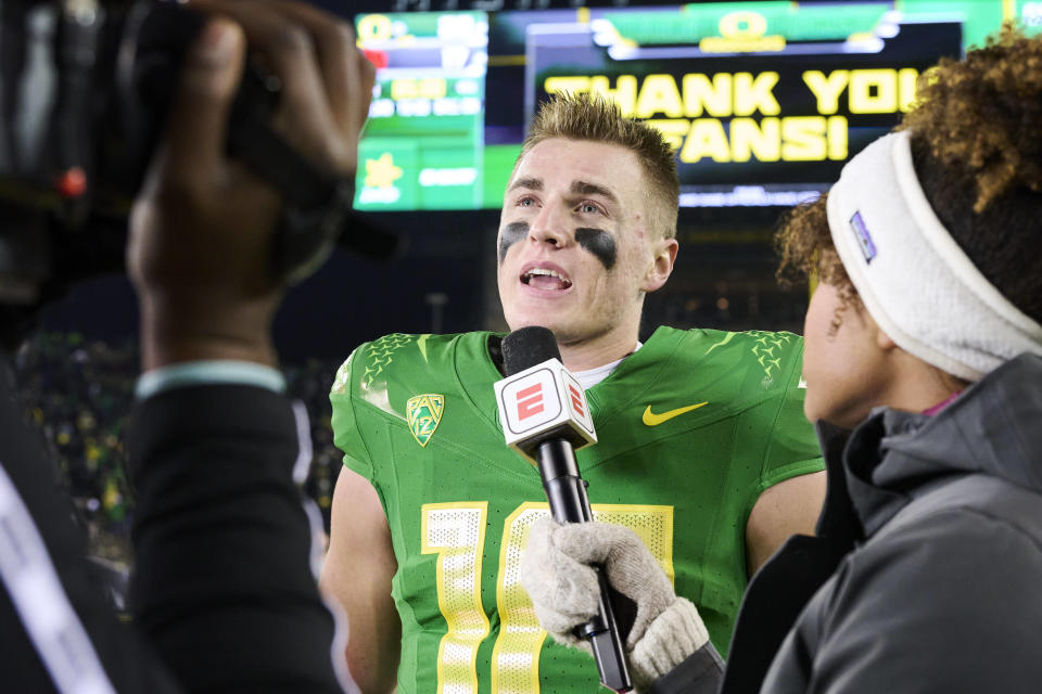 Nov 19, 2022; Eugene, Oregon, USA; Oregon Ducks quarterback <a class="link " href="https://sports.yahoo.com/ncaaf/players/299270" data-i13n="sec:content-canvas;subsec:anchor_text;elm:context_link" data-ylk="slk:Bo Nix;sec:content-canvas;subsec:anchor_text;elm:context_link;itc:0">Bo Nix</a> (10) talks to a reporter after a game against the Utah Utes at Autzen Stadium. The Ducks won the game 20-17. Mandatory Credit: Troy Wayrynen-USA TODAY Sports