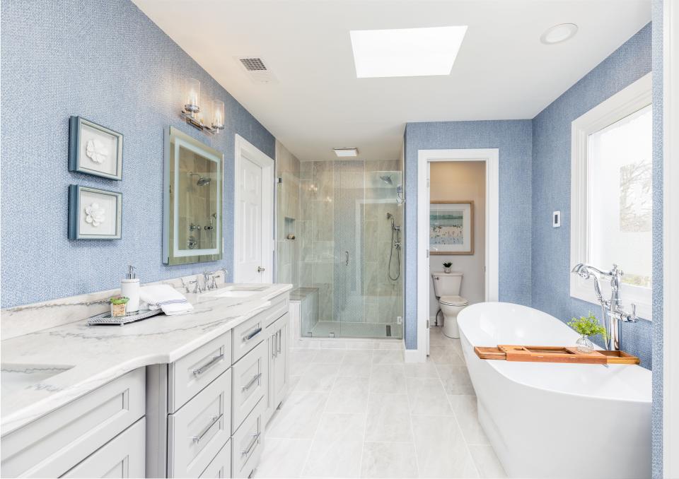 This en suite main bathroom was reconfigured for a larger shower, better access to the bedroom closet, a freestanding soaking tub, and more pleasing aesthetics.