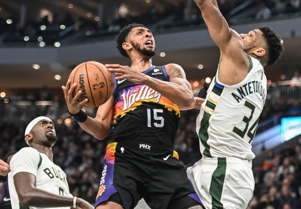 Mar 6, 2022; Milwaukee, Wisconsin, USA; Phoenix Suns guard Cameron Payne (15) looks for a shot against Milwaukee Bucks forward Giannis Antetokounmpo (34) in the second quarter at Fiserv Forum.