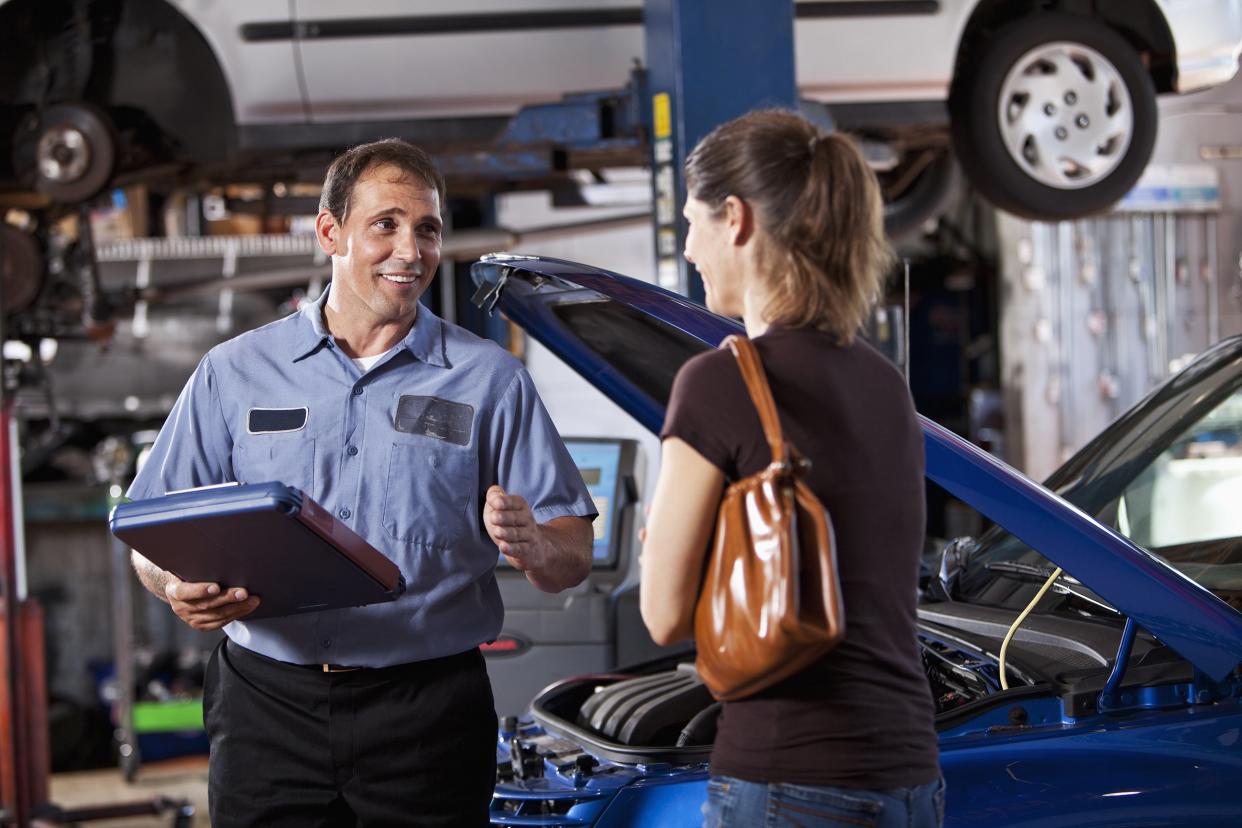 auto mechanic with customer