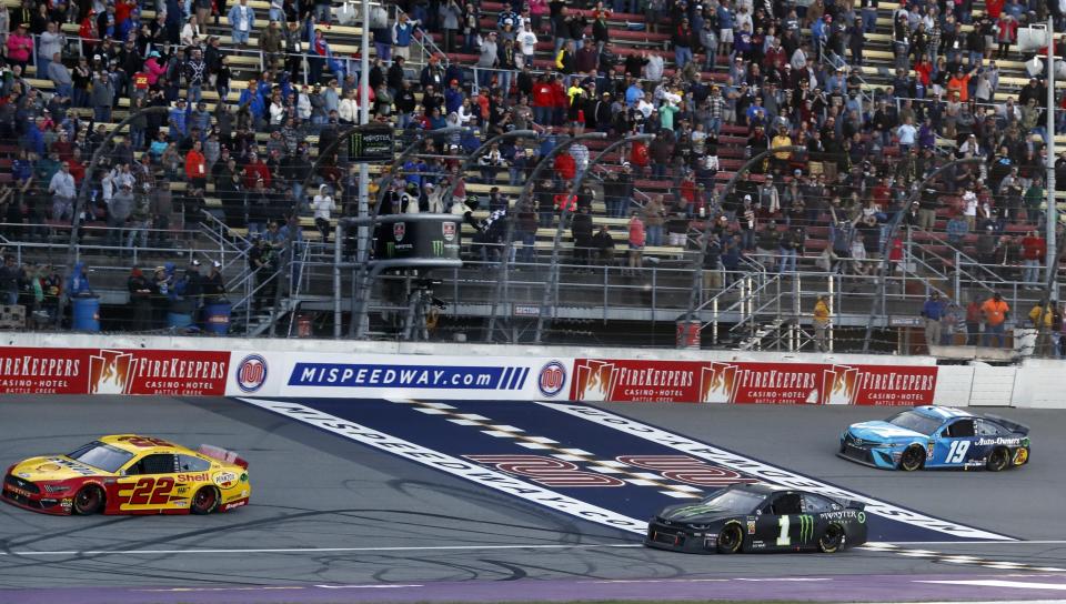 Joey Logano (22) defeats Kurt Busch (1) and Martin Truex Jr. (19) to win a NASCAR Cup Series auto race at Michigan International Speedway, Monday, June 10, 2019, in Brooklyn, Mich. (AP Photo/Carlos Osorio)