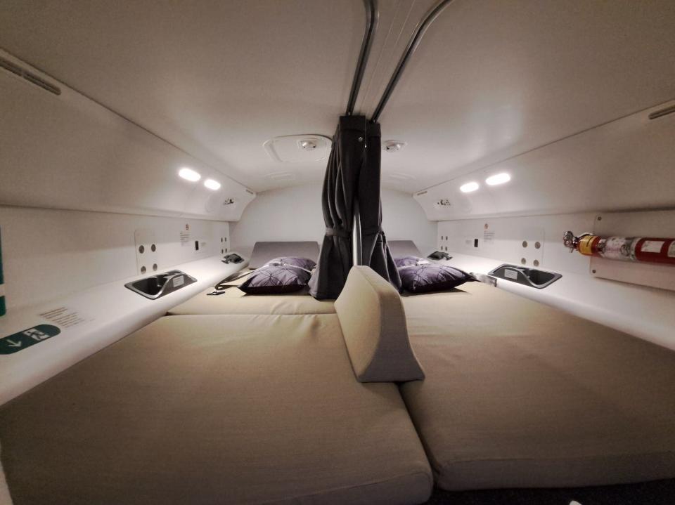 Two bunks lay side by side in a narrow room. They have a curtain allowing pilots to sleep in private during long haul flights.