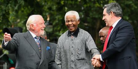 Britain's then Prime Minister Gordon Brown (R) and director Richard Attenborough assist South Africa's former President Nelson Mandela (C) to the podium, during the unveiling ceremony of a statue in Mandela's honour in London's Parliament Square, in this file picture taken August 29, 2007. REUTERS/Daniel Berehulak