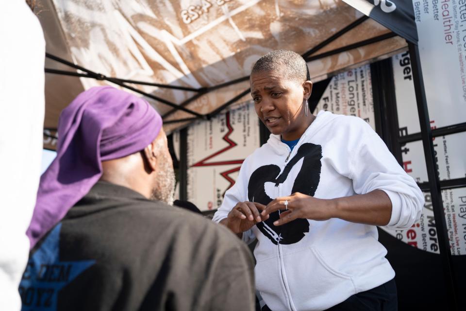 Tara Robinson, right, CEO and co-founder of the Black Heart Association speaks with James Nellums, a 64-year-old Fort Worth resident at the Phoenix Festival on Nov. 4, 2023 during free health screenings as part of the association's annual appearance at the festival.