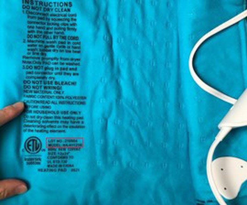 The back of a Mighty Bliss heating pad is shown. The lot number, in black text, is highlighted.
