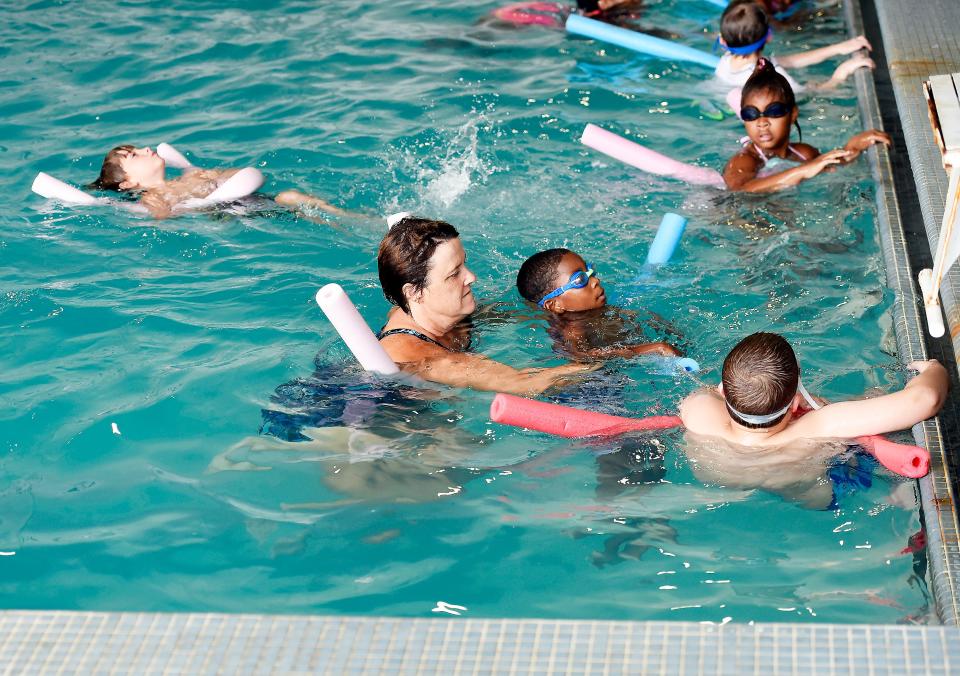 Children are shown taking swimming lessons in the pool at the YMCA of the Coosa Valley. The agency has announced that it will close on April 15 and sell its property at 100 Walnut St.