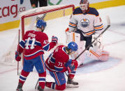 Montreal Canadiens' Jake Evans (71) celebrates with teammate Paul Byron (41) after scoring the first goal against Edmonton Oilers goaltender Mikko Koskinen (19) during the first period of an NHL hockey game in Montreal, Monday, May 10, 2021. (Ryan Remiorz/The Canadian Press via AP)