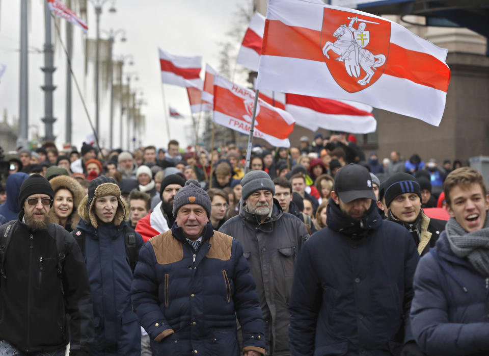 Protesters attend a procession in downtown Minsk, Belarus, Sunday, Dec. 8, 2019. A rally was held to protest closer integration with Russia which protesters fear could erode the post-Soviet independence of Belarus, a nation of 10 million. (AP Photo/Sergei Grits)