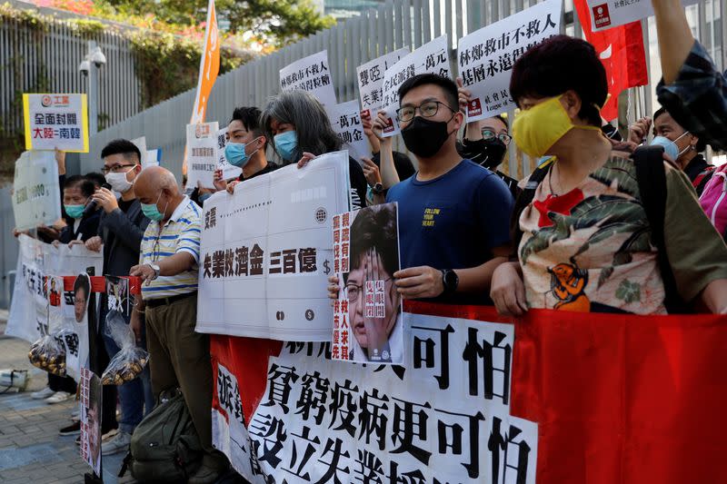 Protesters shout slogans before Hong Kong Financial Secretary Paul Chan delivers the annual budget, outside the Legislative Council in Hong Kong