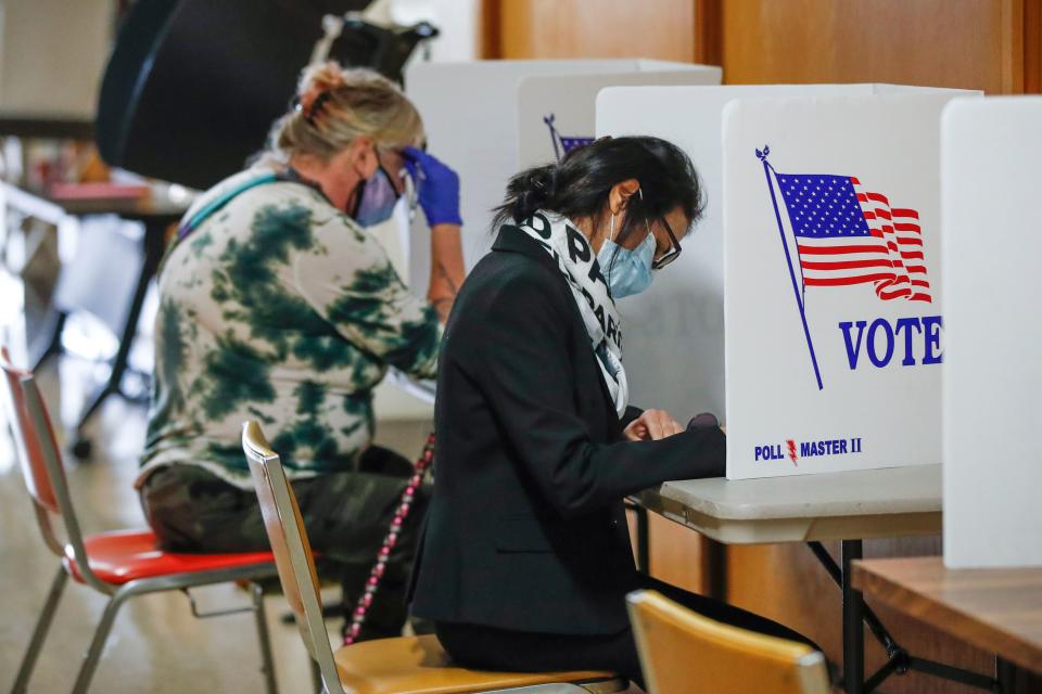 People vote inside City Hall on the first day of in-person early voting for the November 3rd elections in Kenosha, Wisconsin, on October 20, 2020. - Early voting kicked off October 20, 2020 in Wisconsin, a state fought over by President Donald Trump and Democratic challenger Joe Biden as their contentious White House race enters its final 14-day stretch. (Photo by KAMIL KRZACZYNSKI / AFP) (Photo by KAMIL KRZACZYNSKI/AFP via Getty Images)