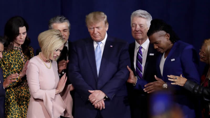 Pastor Paula White, left, and other faith leaders pray with President Donald Trump, center, during a rally for evangelical supporters at the King Jesus International Ministry church on Jan. 3, 2020, in Miami.