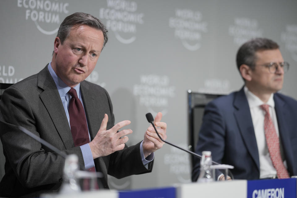 Britain's Foreign Secretary David Cameron, left, and Ukraine's Foreign Minister Dmytro Kuleba take part in a panel discussion at the Annual Meeting of World Economic Forum in Davos, Switzerland, Wednesday, Jan. 17, 2024. The annual meeting of the World Economic Forum is taking place in Davos from Jan. 15 until Jan. 19, 2024.(AP Photo/Markus Schreiber)