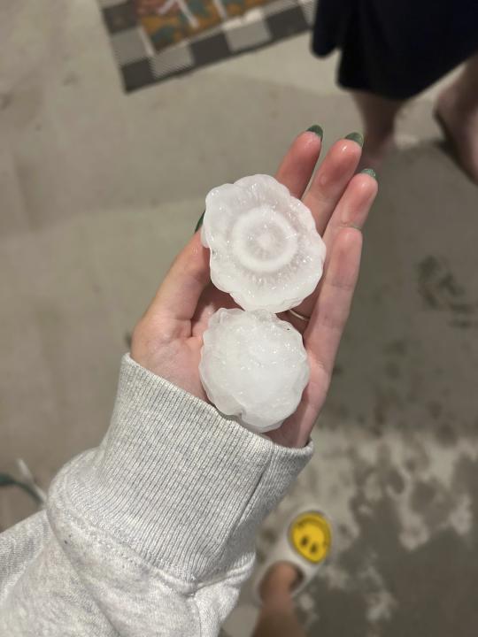 In this image provided by Jeremy Crabtree, large chunks of hail are shown, Wednesday night, March 13, 2024, in Shawnee, Kan. Volatile weather was honing in on parts of Kansas and Missouri Wednesday night, with some storms bringing massive chunks of hail. (Jeremy Crabtree via AP)