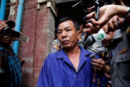 Detained Police Captain Moe Yan Naing is escorted by police as he leaves after the court hearing in Yangon, Myanmar May 9, 2018. REUTERS/Stringer