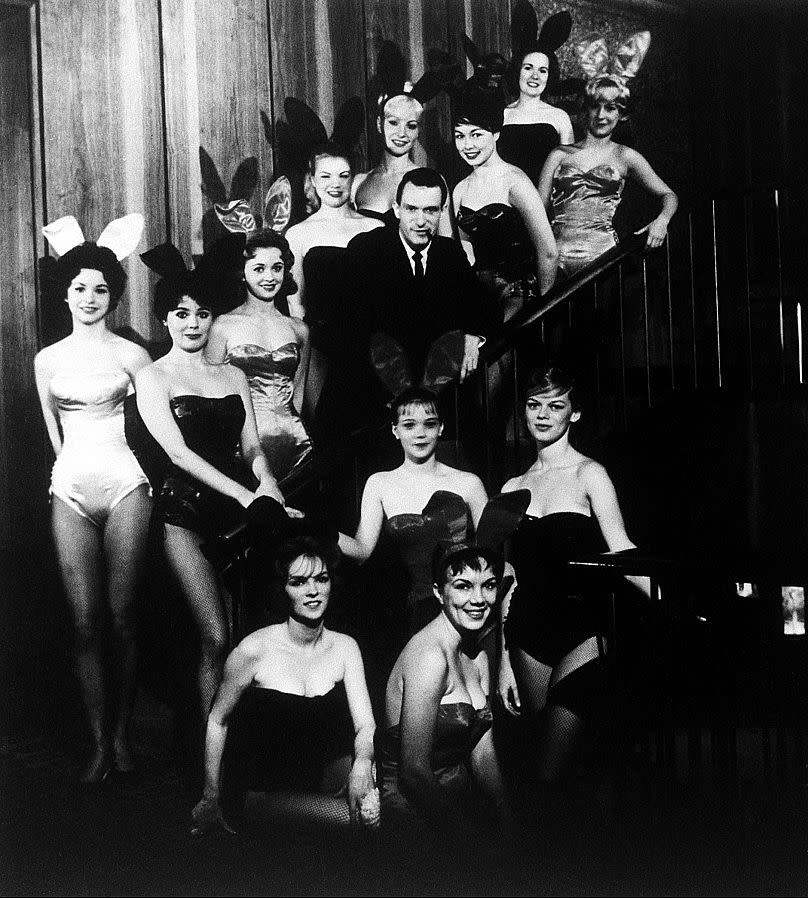 Hugh Hefner, founder and chairman of the Playboy Enterprises, Inc., is pictured amid a group of Bunnies, at the flagship Playboy Club, in Chicago, Ill., circa 1960.