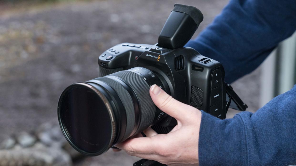  Blackmagic Cinema Cam 6K held in a pair of hands. 