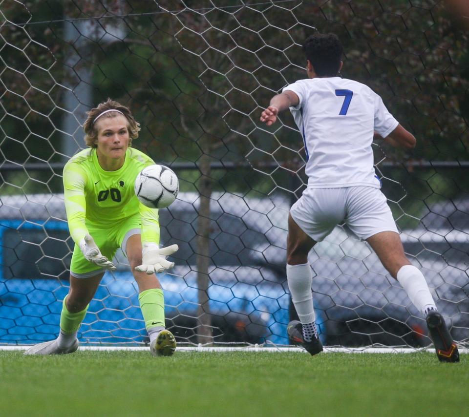 Pleasant Valley's Jack Kilstrom (00) makes the save against Waukee Northwest's Abdullah Iqbal (7) during the Class 3A Boys State Soccer Tournament championship.