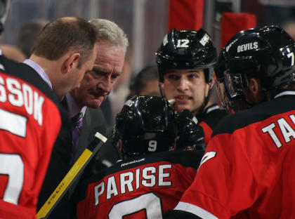 NEWARK, NJ - NOVEMBER 08: Head coach Peter DeBoer and assistant coach Larry Robinson of the New Jersey Devils give the team last minute instructions during the game against the Carolina Hurricanes at the Prudential Center on November 8, 2011 in Newark, New Jersey. The Devils defeated the Hurricanes 3-2. (Photo by Bruce Bennett/Getty Images)