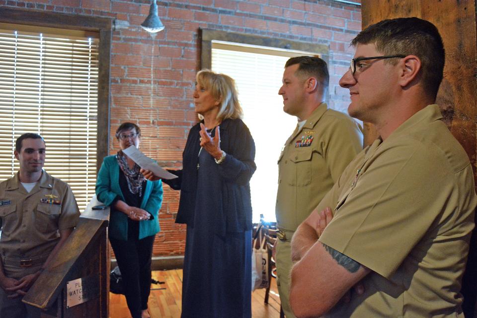 Anne Moore, third from left, Mayor's Task Force on the USS Columbia chair, introduces officers and enlisted sailors from that submarine Wednsday at Flat Branch Pub and Brewing. Joining her, from left, are Lt. j.g. Zachary Rosen, Mayor Barbara Buffaloe, Cmdr. Brad Foster, Chief Petty Officer Matt Choiniere and, not pictured, Petty Officer 1st Class Billy Kilmer.