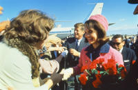 President John F. Kennedy and his wife, Jackie, greet a crowd at Love Field in Dallas upon arrival for a campaign tour on the day of JFK's assassination. (Photo: Art Rickerby/The Life Picture Collection/Getty Images)