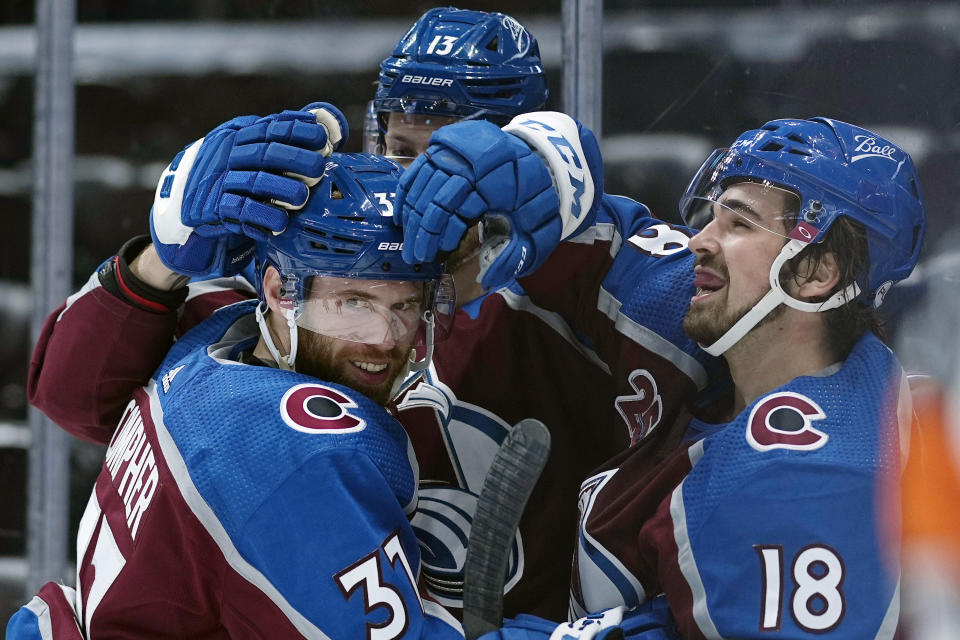 FILE - In this May, 12, 2021, file photo, Colorado Avalanche left wing J.T. Compher (37) is congratulated by teammates Valeri Nichushkin (13) and Alex Newhook (18) after scoring his third goal against the Los Angeles Kings during the second period of an NHL hockey game in Denver. Newhook went from playing in college to making an impact on his team at the most important time of the year. (AP Photo/Jack Dempsey, File)