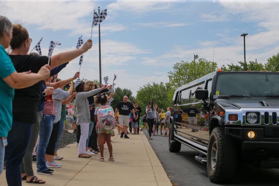 James Cole Elementary school, teachers, staff and administors wave goodbye to Kelly Curtis, as she leaves Cole in a limousine on her last day of academic career, on Thursday, May 25, 2023, in Lafayette, Ind.