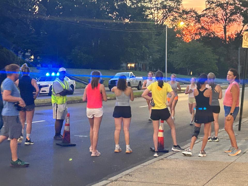 A batch of runners, part of a crowd of 1,000, cross the finish line of "Finish Liza's Run" outside of the Cathedral of the Immaculate Conception. The run was started last year as a way to honor 34-year-old Eliza Fletcher, who was abducted and killed during a routine morning run in 2022.