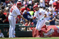 Washington Nationals' Kyle Schwarber, right, celebrates his home run with with third base coach Bob Henley (15) during the fifth inning of a baseball game against the New York Mets, Sunday, June 20, 2021, in Washington. (AP Photo/Nick Wass)